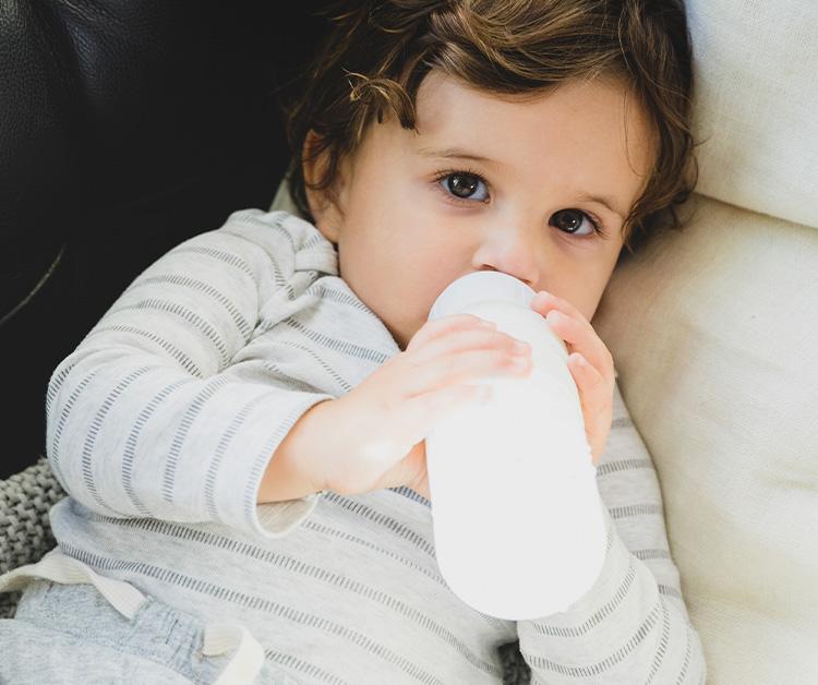 Toddler drinking milk from a bottle