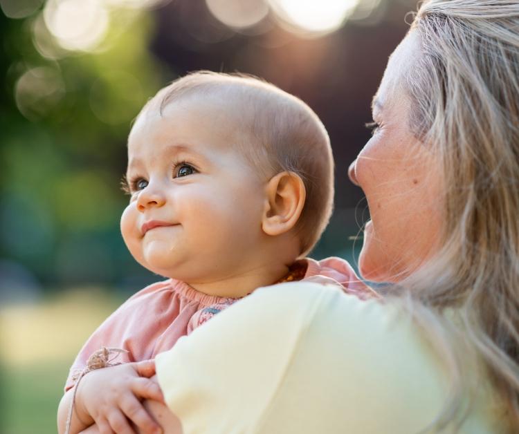 Mom holding smiling baby
