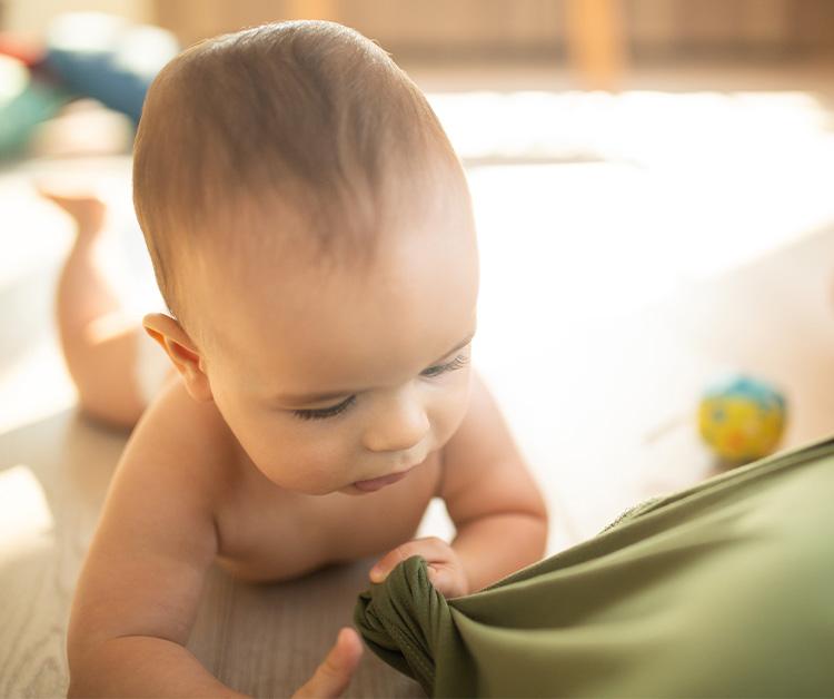 Baby grabbing his mom shirt