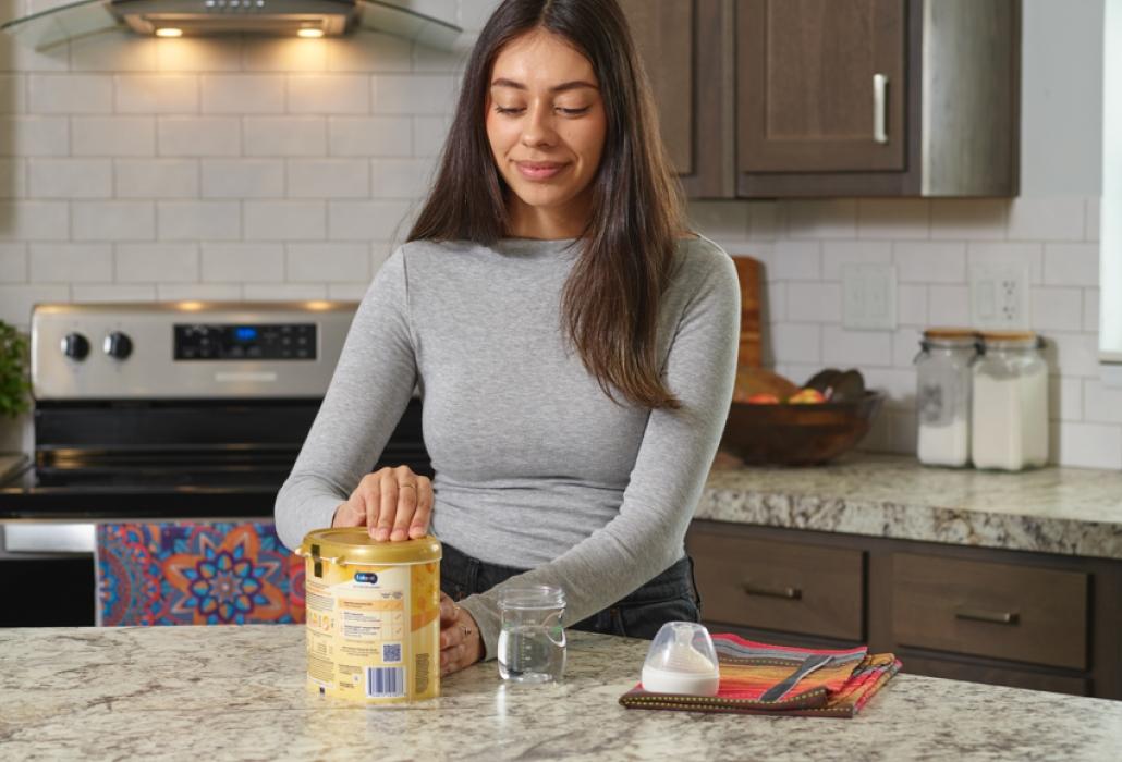 Mom preparing to make a bottle of formula