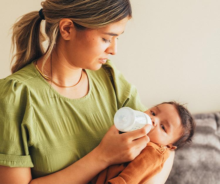 Mother feeding her baby a bottle