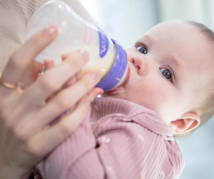 Mom feeding baby a bottle