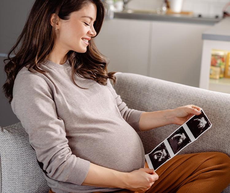 Pregnant woman looking at ultrasound images