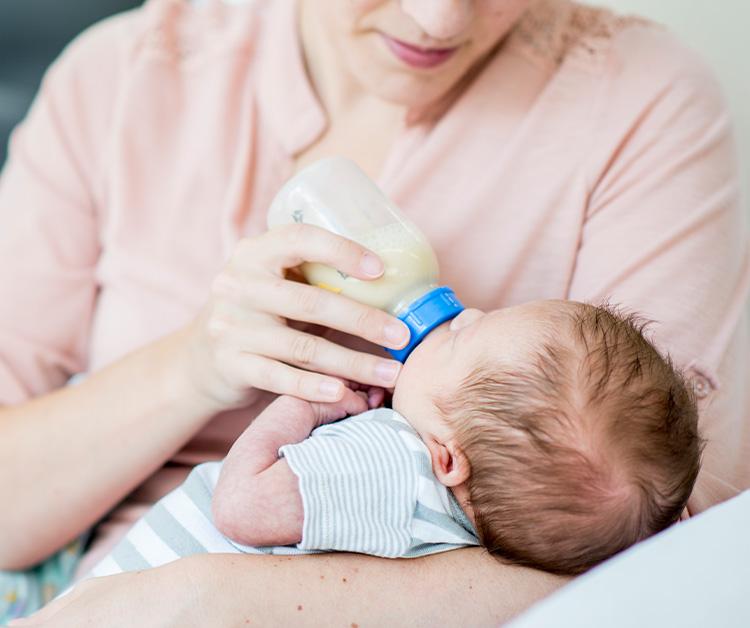 Little baby being bottle fed