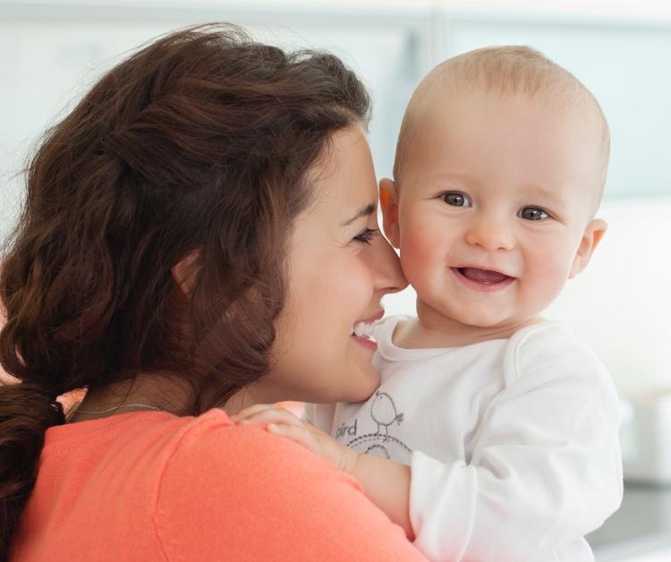 Mom sweetly nuzzling infant