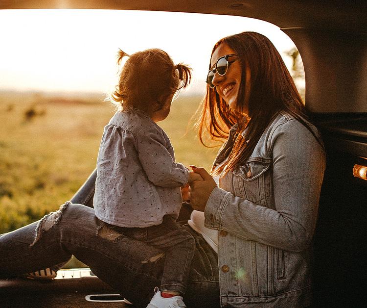 Mother holding her baby hands