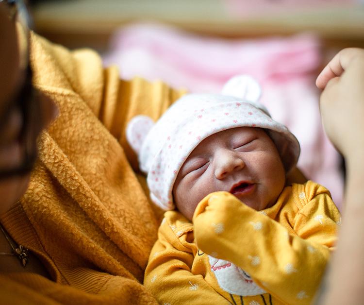 Parent holding their newborn baby