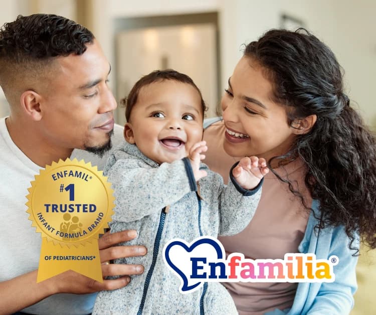 Mom and dad holding baby and smiling