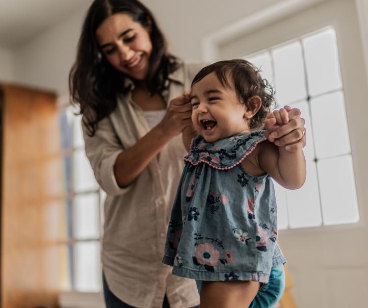 Mamá ayudando al bebé a caminar