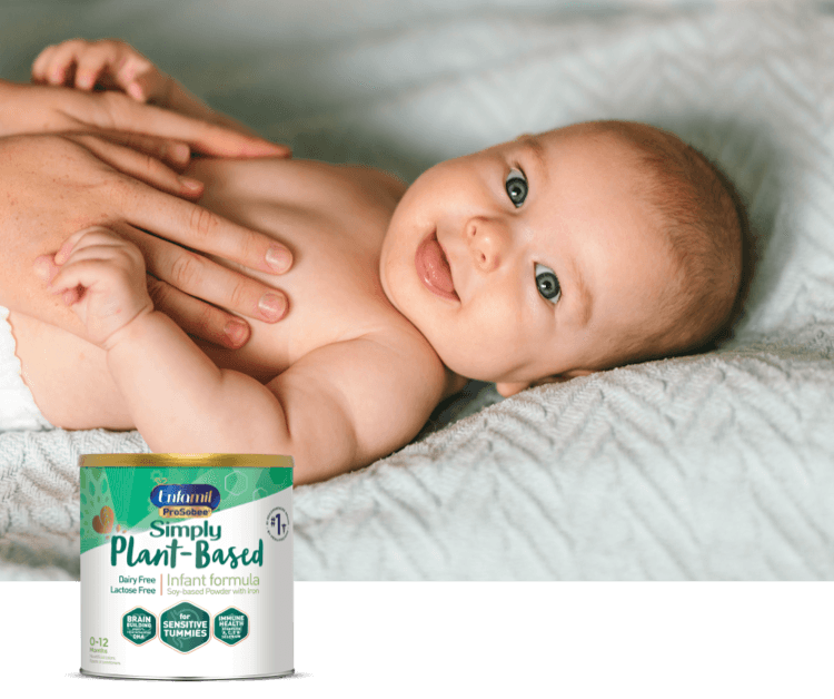 Mom laying baby on a bed