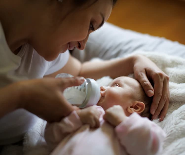 Mother feeding her baby a bottle