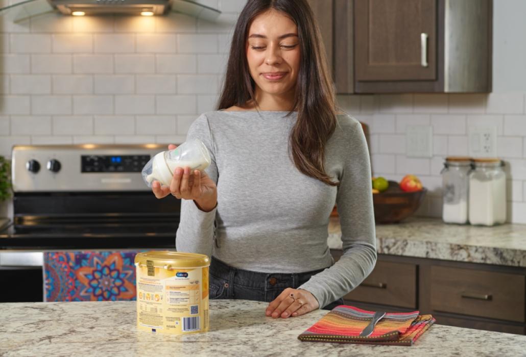 Mom shaking a bottle of formula