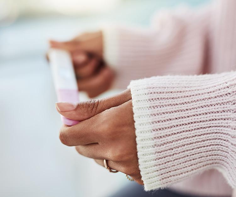 Woman holding pregnancy test