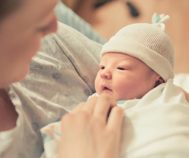 Parent holding a premature baby
