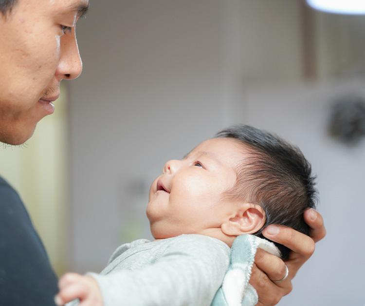 Dad holding his smiling baby